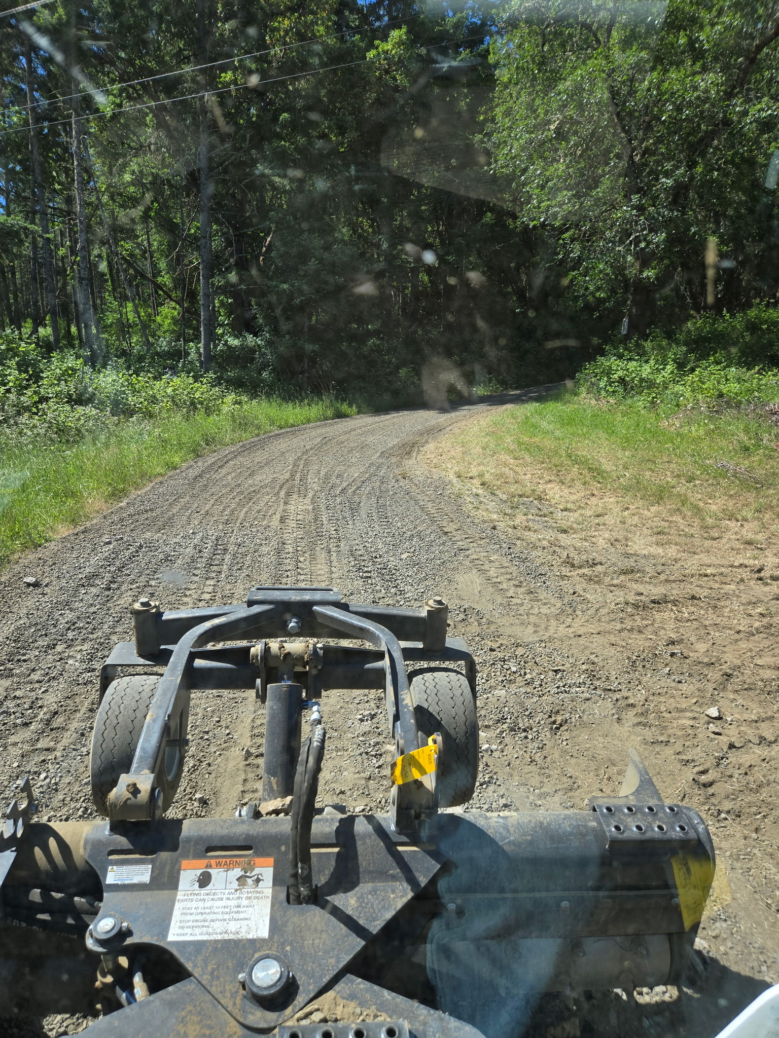 Smooth, graded and crowned driveway after power raking